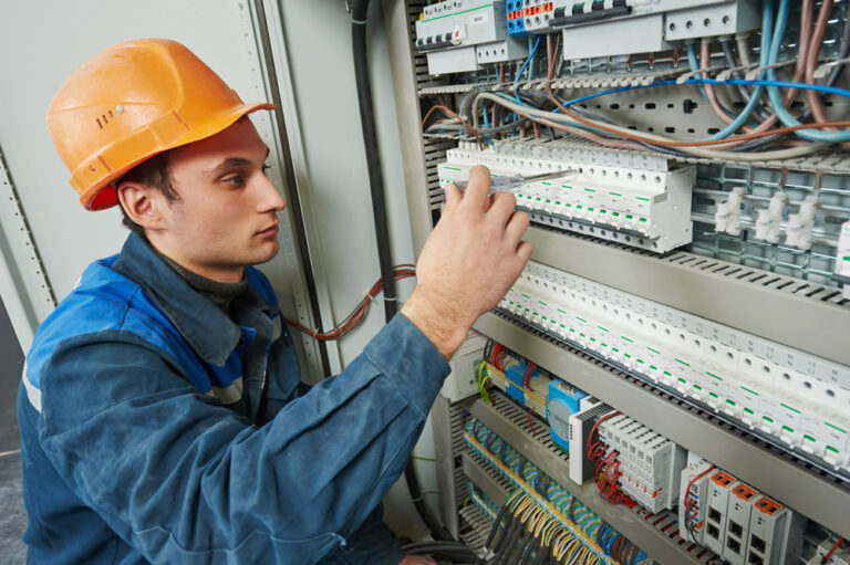 Electrician Works With Electric Meter Tester In Fuse Box