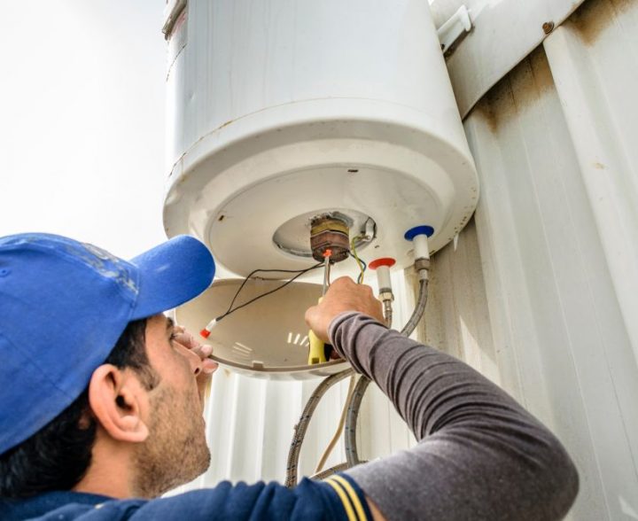 Electrician Fixing Boiler — Electrical Service in Grafton, NSW