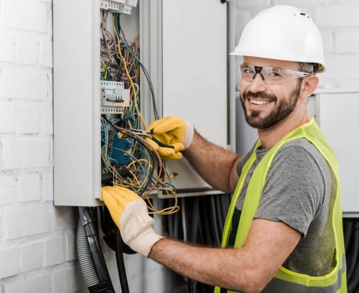 Electrician Using Pliers in Electrical Box