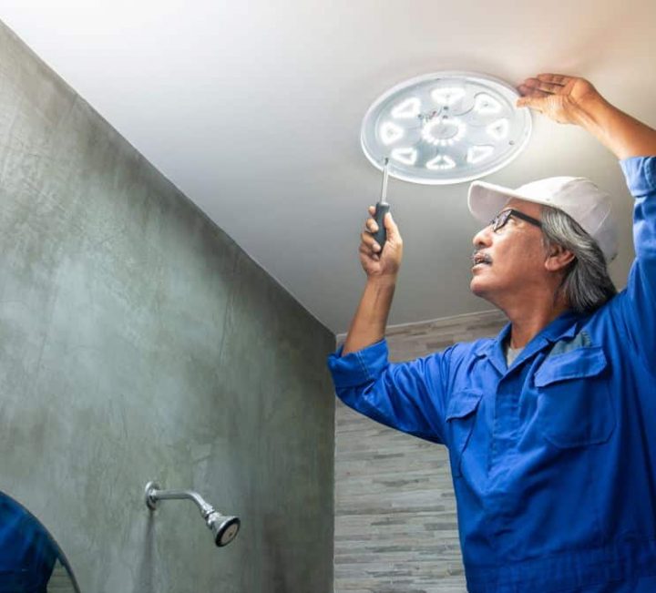 Electrician Fixing A Light In A Bathroom- Grafton, NSW