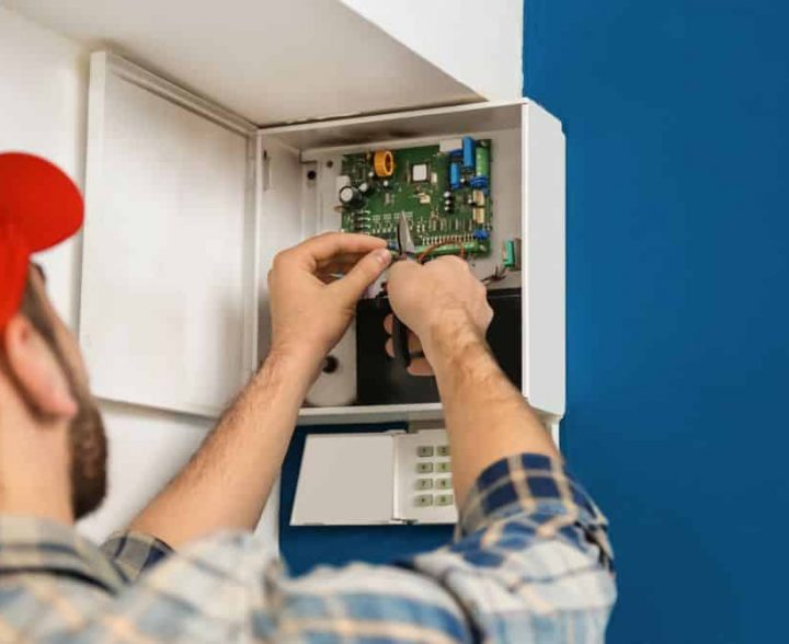 Electrician Repairing An Alarm System