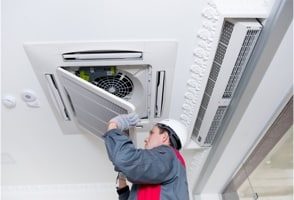 man fixing air condition